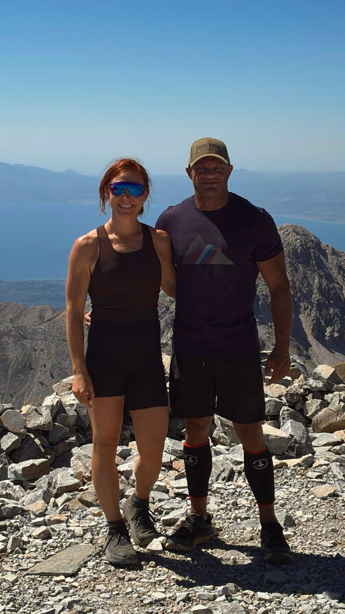 The two of us on the summit of Mount Taygetos with mountains and sea behind