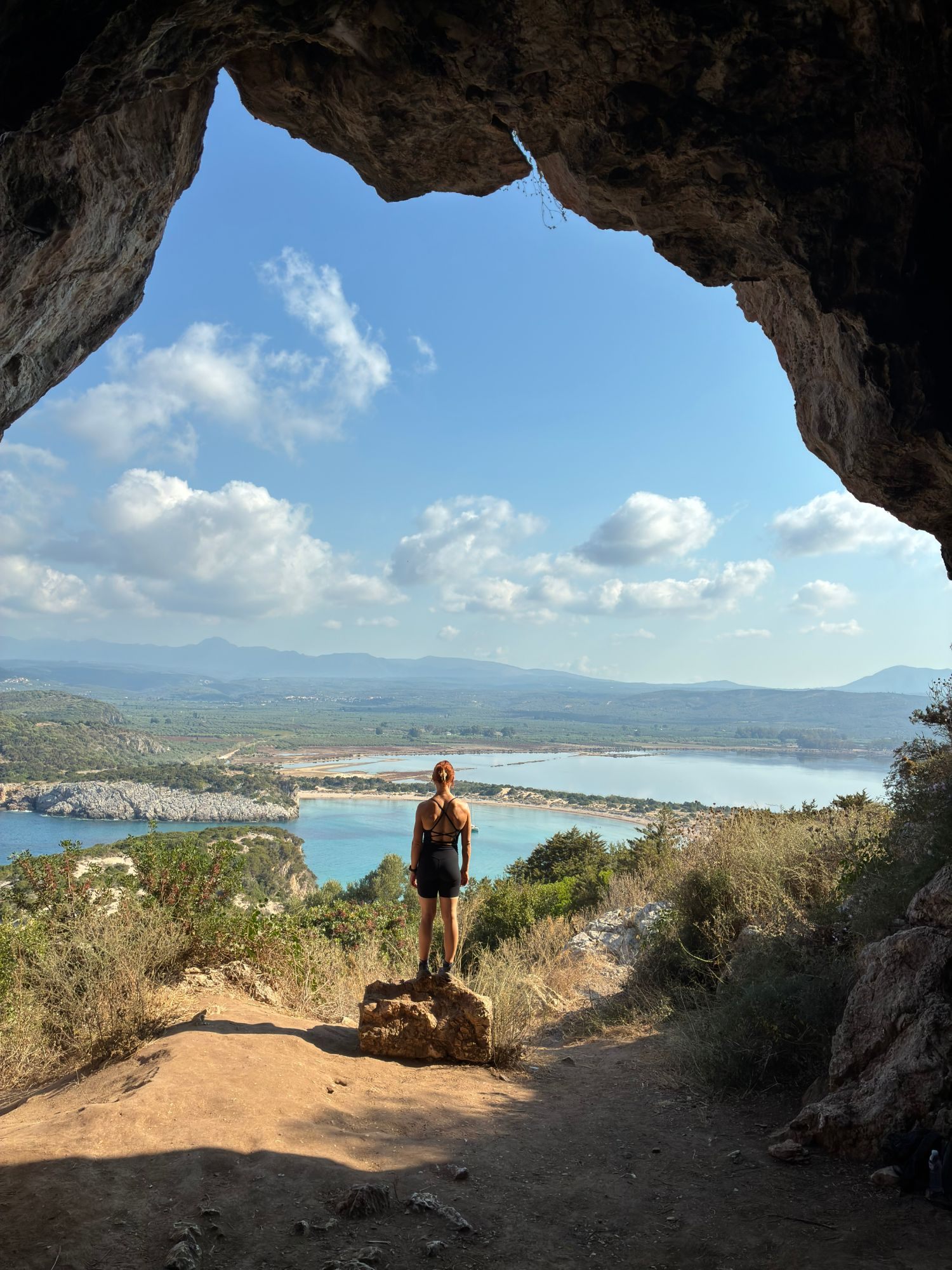 Kristine at the mouth of Nestor's Cave looking out over Voidokilia Beach and Gialova Lagoon